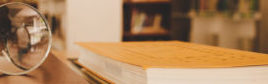 Book in library with old open textbook, stack piles of literatur